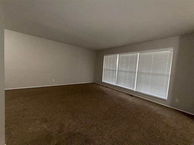 empty room with dark carpet