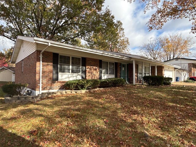 ranch-style house with a front lawn and a garage