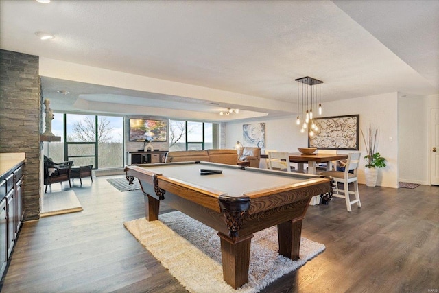 playroom with a raised ceiling, wood-type flooring, and pool table