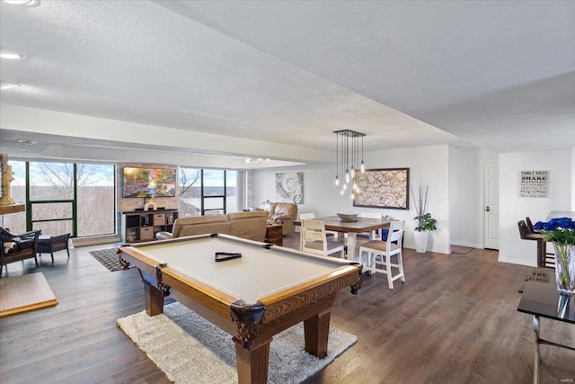 recreation room with a textured ceiling, dark hardwood / wood-style floors, and billiards