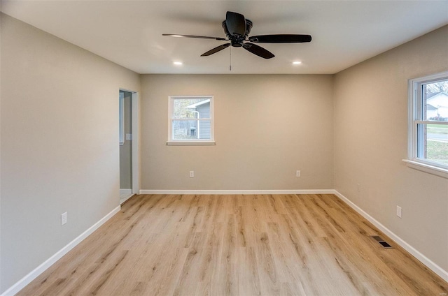 unfurnished room with light hardwood / wood-style floors, ceiling fan, and a healthy amount of sunlight