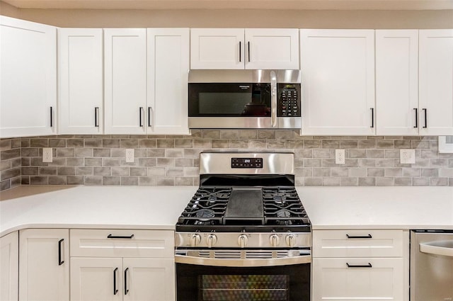 kitchen with white cabinets, backsplash, and stainless steel appliances