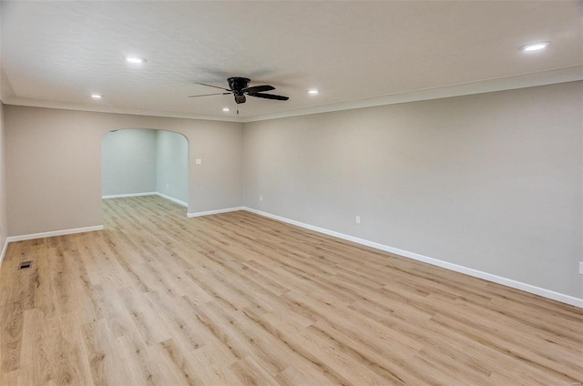 spare room with crown molding, ceiling fan, and light hardwood / wood-style floors