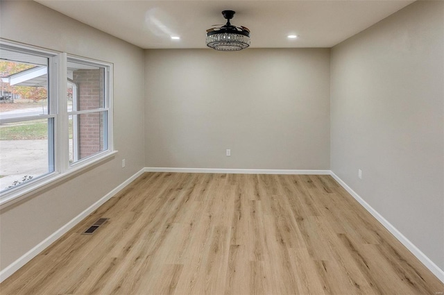 spare room featuring light wood-type flooring