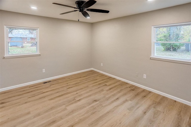 unfurnished room with ceiling fan, light hardwood / wood-style flooring, and a healthy amount of sunlight