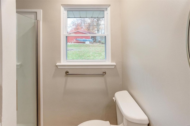 bathroom featuring toilet and walk in shower