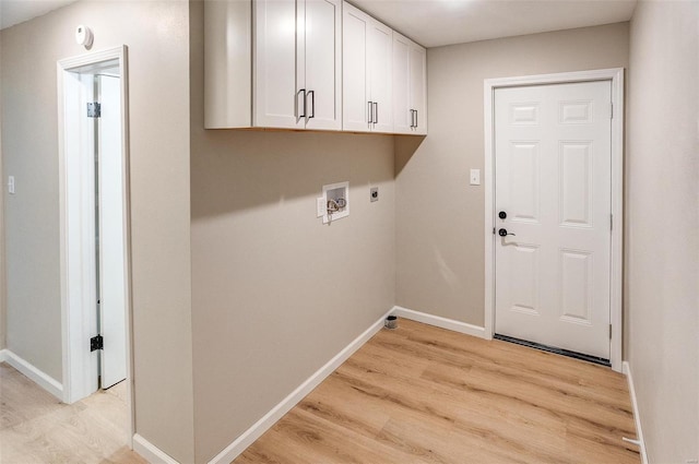 laundry area with cabinets, hookup for a washing machine, light hardwood / wood-style flooring, and electric dryer hookup