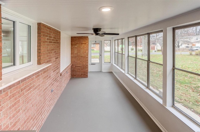 unfurnished sunroom with a wealth of natural light and ceiling fan