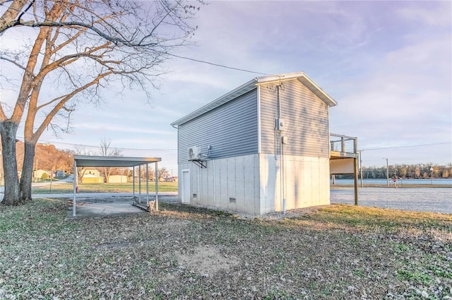 view of side of home with a carport