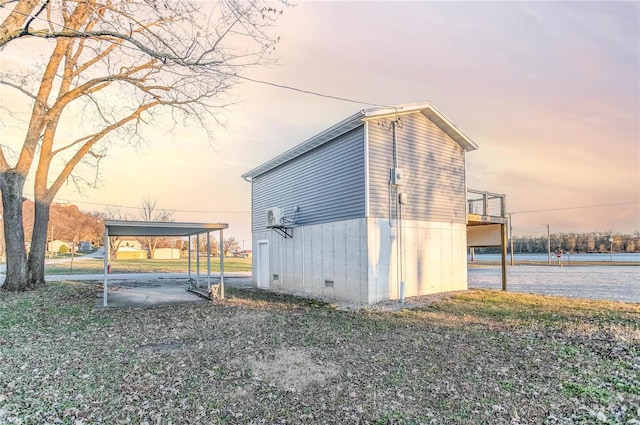 property exterior at dusk featuring a carport