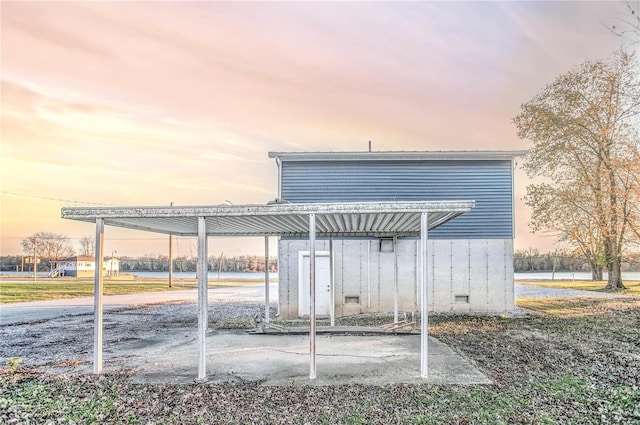 back house at dusk featuring a water view