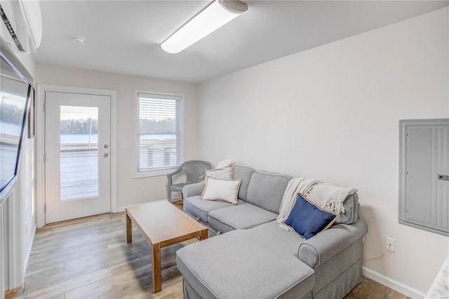 living room with electric panel and light wood-type flooring