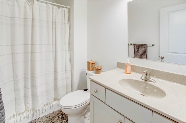 bathroom with vanity, toilet, and walk in shower