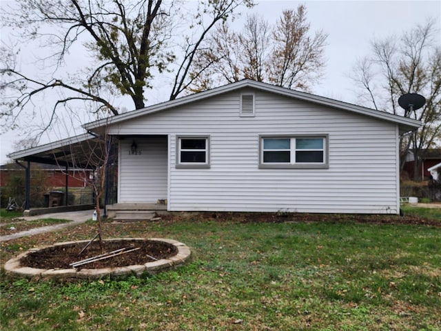 back of house with a lawn