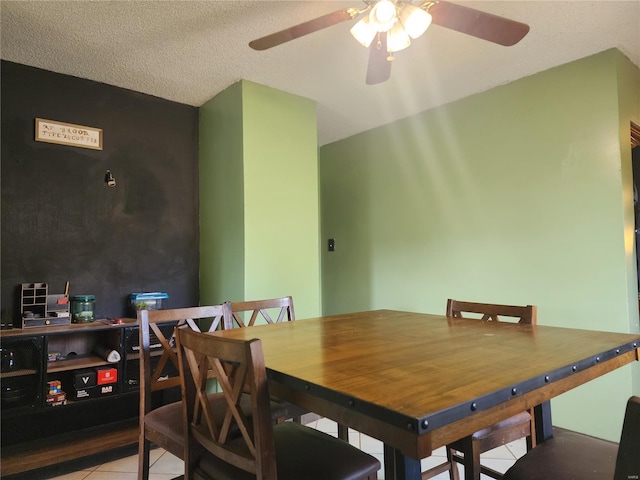 tiled dining room featuring ceiling fan and a textured ceiling