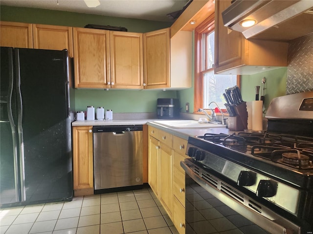 kitchen with black appliances, sink, light brown cabinetry, tasteful backsplash, and light tile patterned flooring