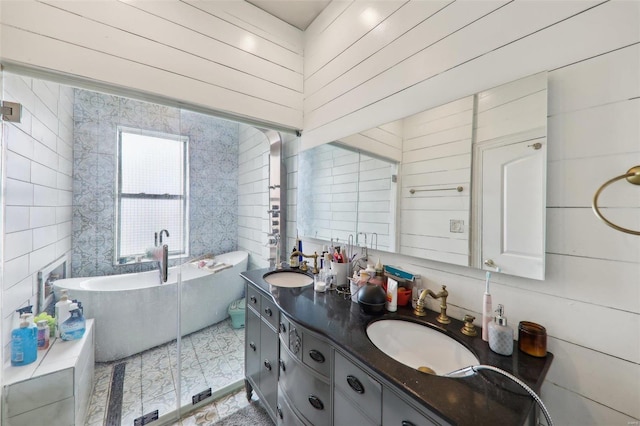 bathroom featuring vanity and a tub to relax in