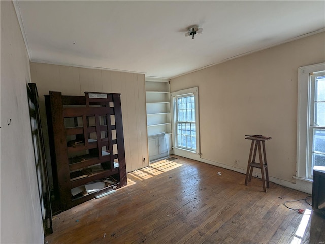 empty room featuring hardwood / wood-style flooring and ornamental molding