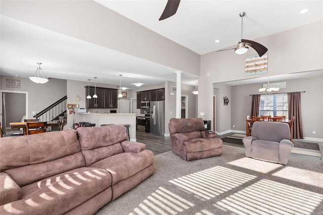 living room featuring light hardwood / wood-style flooring and ceiling fan with notable chandelier