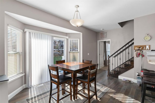 dining space featuring dark wood-type flooring