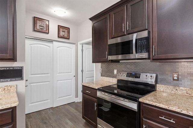 kitchen with stainless steel appliances, tasteful backsplash, light stone counters, dark hardwood / wood-style flooring, and dark brown cabinets