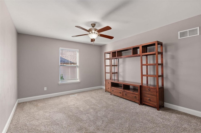 unfurnished bedroom with ceiling fan, light carpet, and a closet