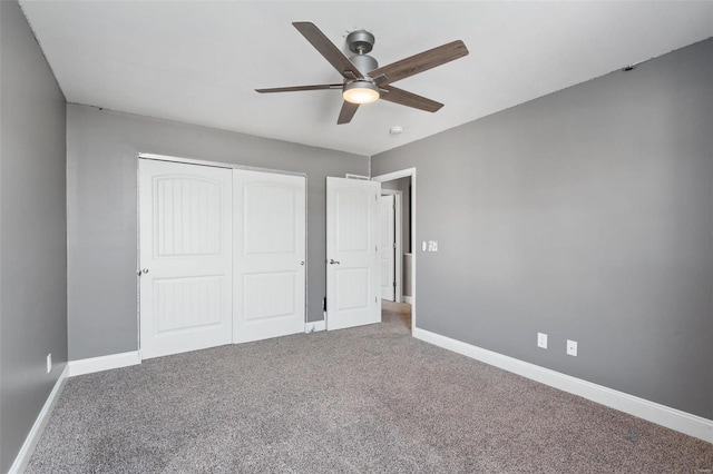 unfurnished bedroom featuring carpet, a closet, and ceiling fan