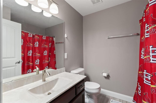 bathroom with vanity, wood-type flooring, and toilet