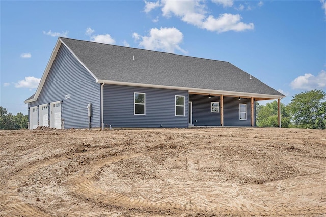 back of house featuring a garage