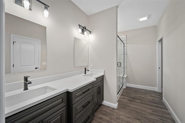 bathroom featuring vanity, hardwood / wood-style flooring, and an enclosed shower