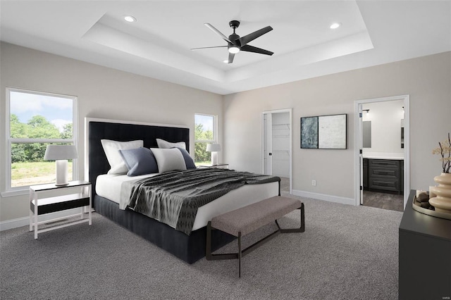 bedroom with carpet flooring, ensuite bathroom, multiple windows, and ceiling fan