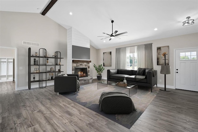 living room with beam ceiling, ceiling fan, high vaulted ceiling, a fireplace, and hardwood / wood-style flooring