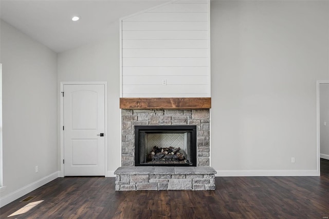 unfurnished living room featuring a fireplace, dark wood-type flooring, and lofted ceiling