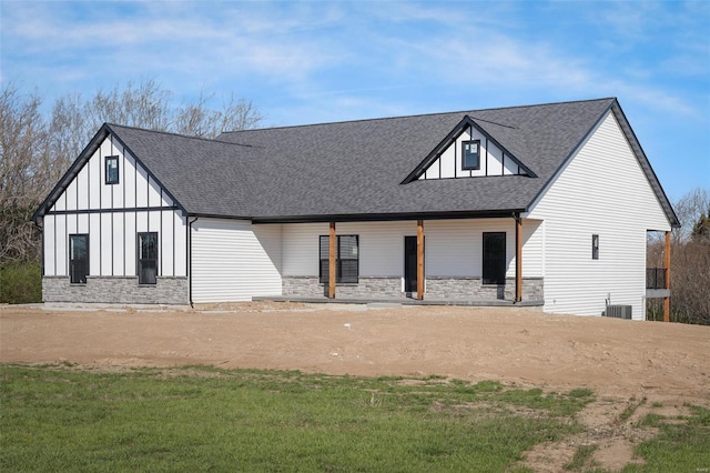 view of front of property with a front yard and central AC