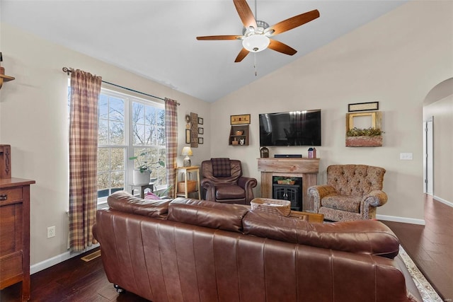 living room featuring ceiling fan, dark wood-type flooring, and vaulted ceiling