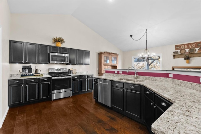 kitchen featuring decorative light fixtures, sink, stainless steel appliances, high vaulted ceiling, and dark hardwood / wood-style flooring