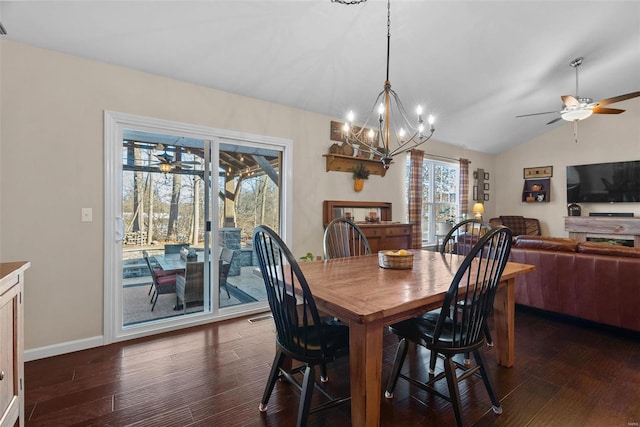 dining room with ceiling fan, dark hardwood / wood-style flooring, and vaulted ceiling