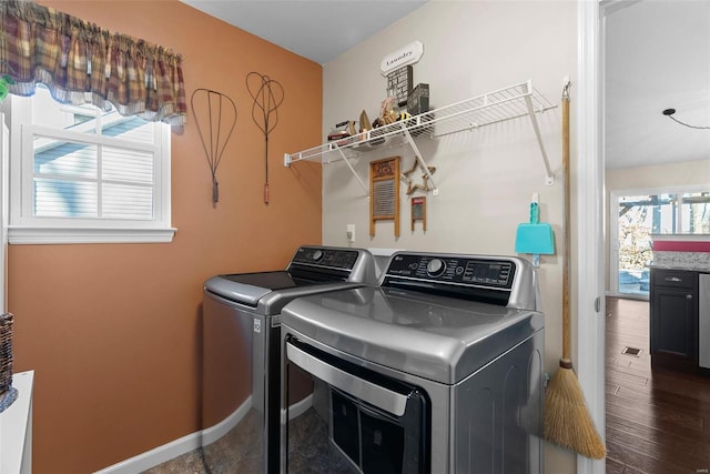 clothes washing area featuring washer and dryer and dark hardwood / wood-style flooring