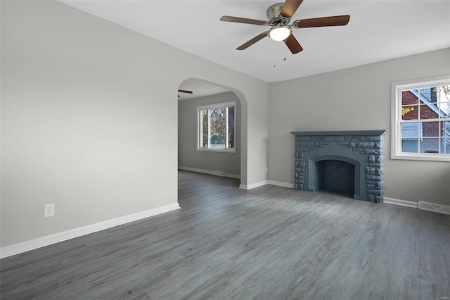 unfurnished living room featuring ceiling fan and dark wood-type flooring