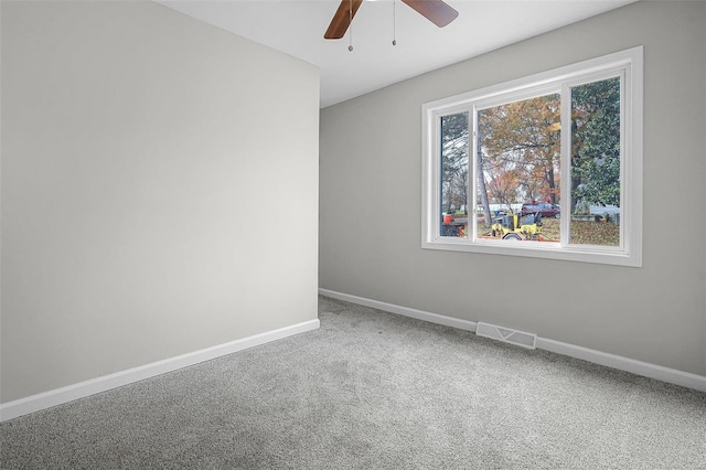 unfurnished room featuring ceiling fan and carpet floors