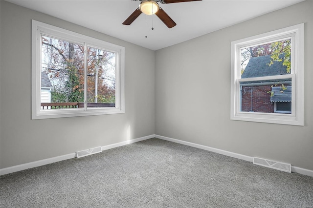 empty room with carpet flooring and ceiling fan