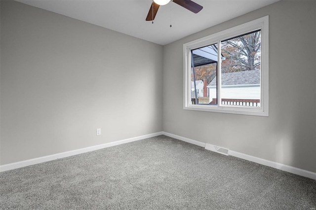 spare room with carpet and ceiling fan