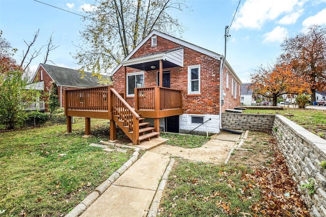 rear view of property with a deck and a yard