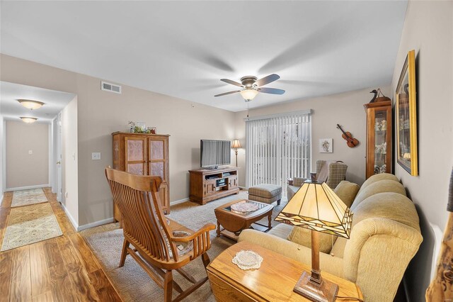 living room featuring ceiling fan and light hardwood / wood-style floors