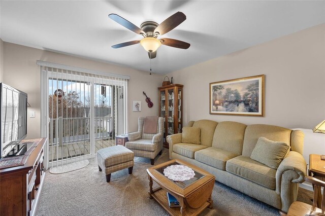 living room featuring carpet flooring and ceiling fan