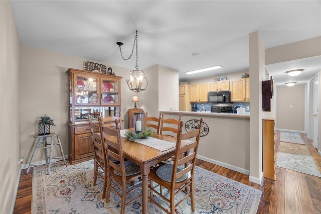 dining room with a chandelier and light hardwood / wood-style floors