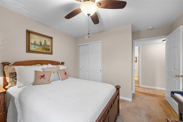 carpeted bedroom with a closet and ceiling fan