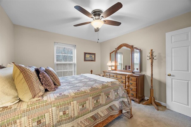 bedroom featuring ceiling fan and light carpet