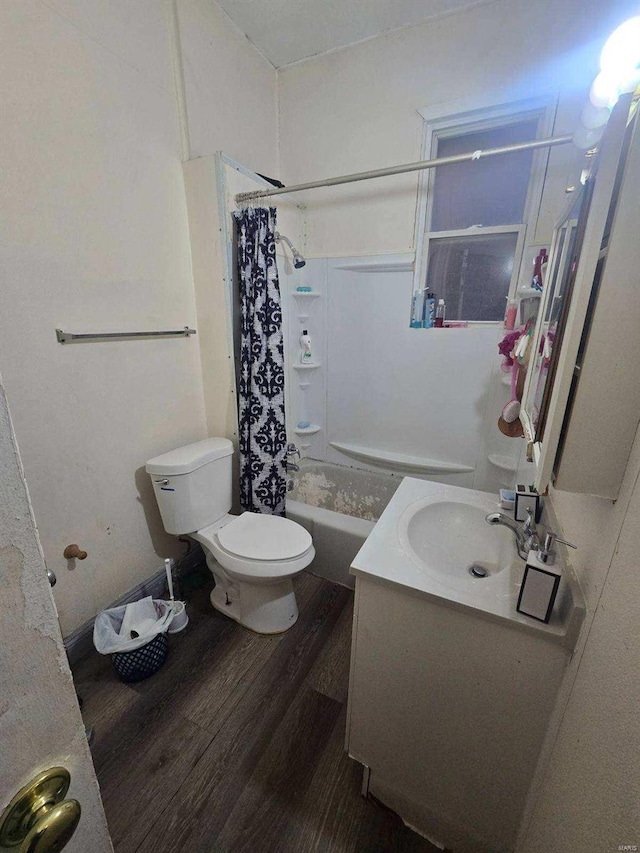 full bathroom with hardwood / wood-style floors, vanity, toilet, and shower / bath combo