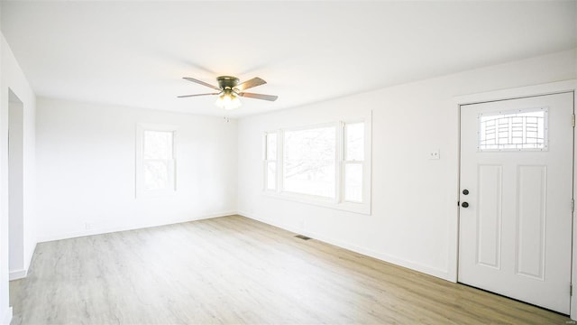 foyer entrance with ceiling fan and light hardwood / wood-style flooring